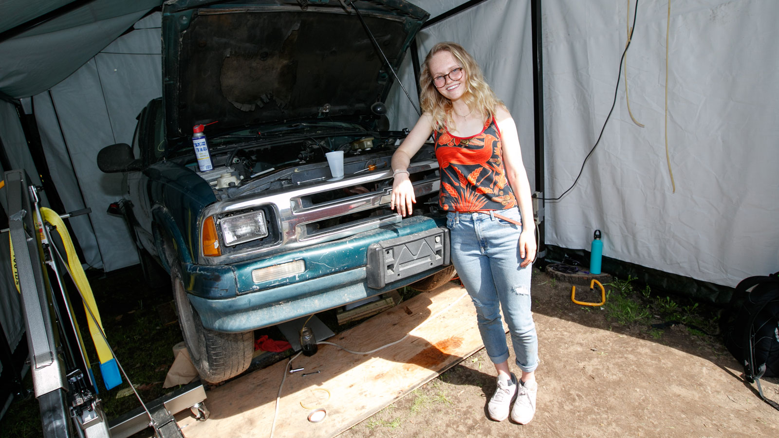 Ellie Cooper with the pickup truck that she converted to electric power