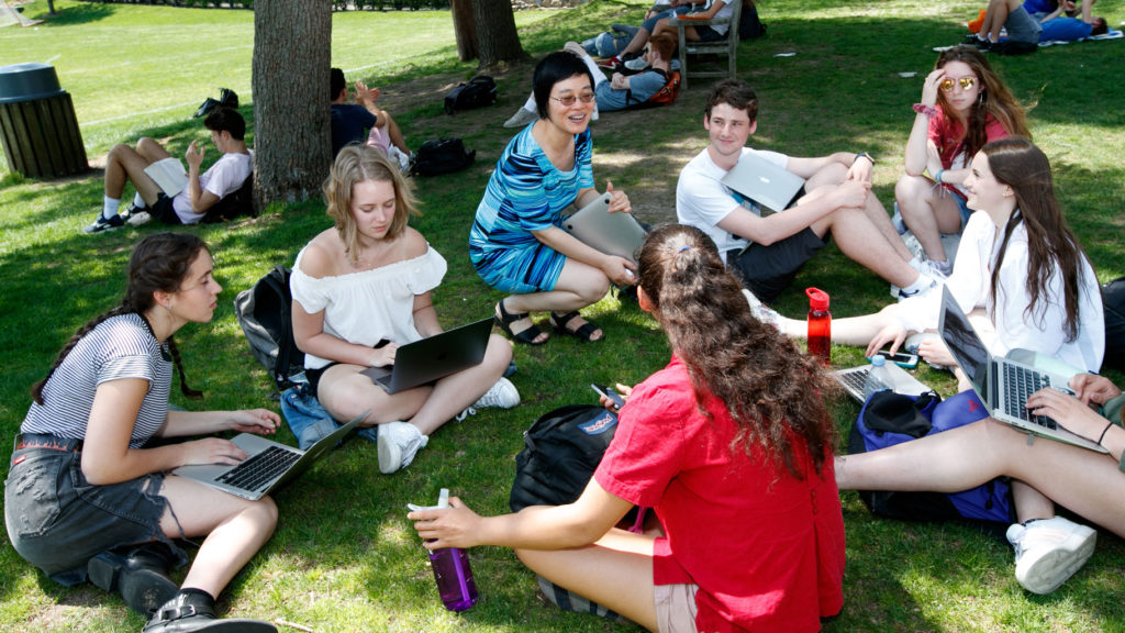 In warm weather, a Mandarin class meets outside on Jones Lawn.