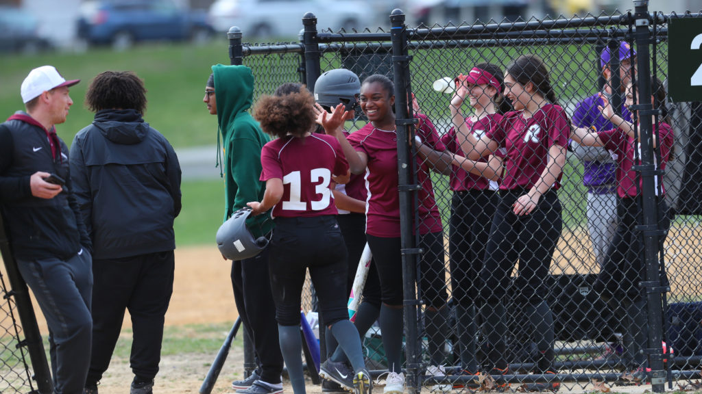 The Middle School girls softball team celebrates a run during a game in Van Cortlandt Park.
