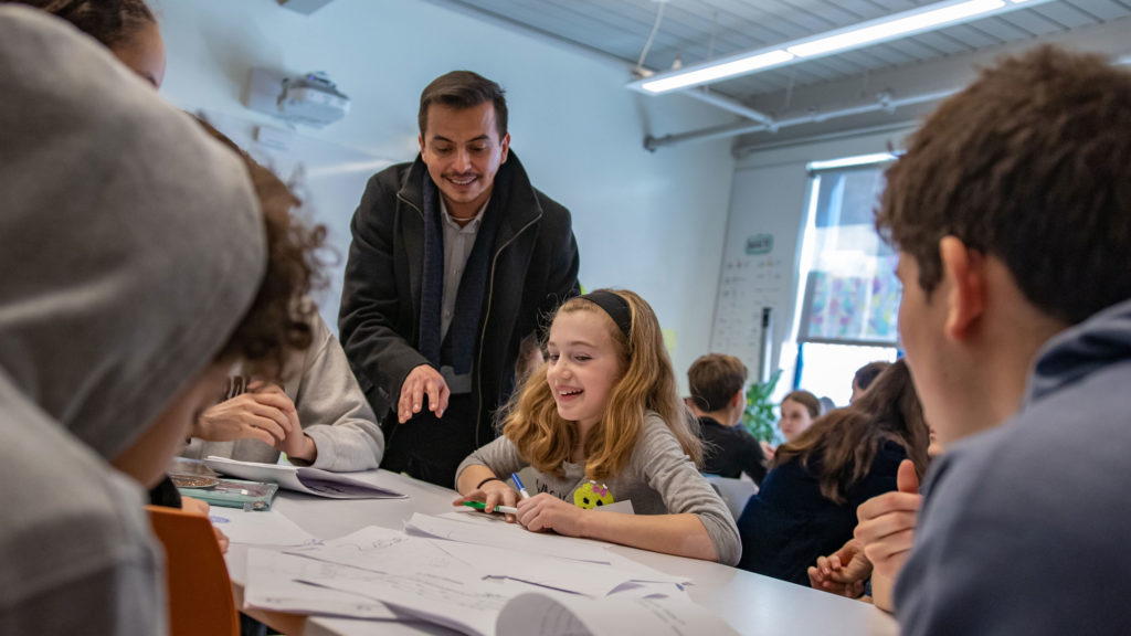 Dr. Cristian Baidal, an Upper School language teacher, takes part in a Lower School Spanish class.