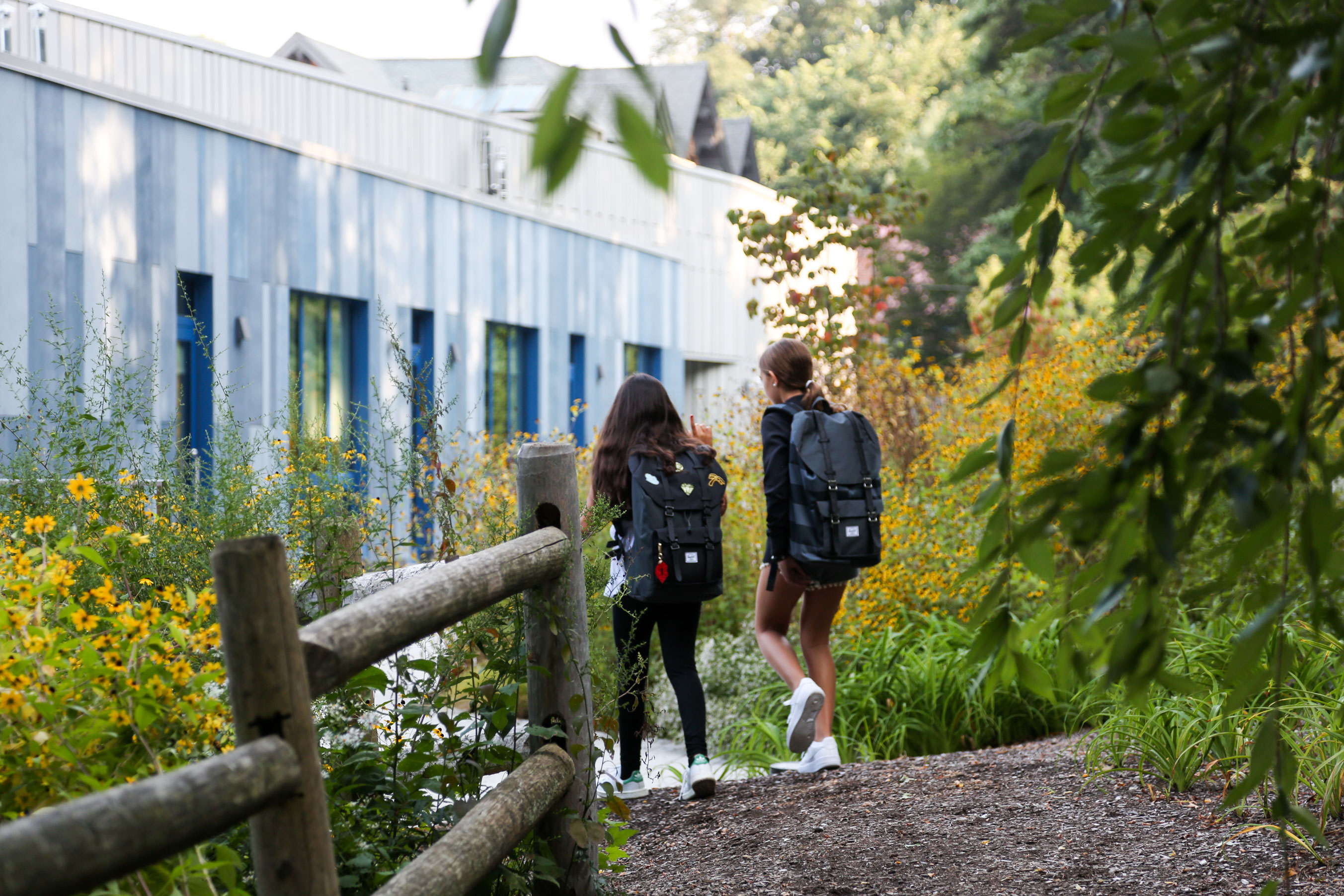 Two students walk toward the Upper Learning Building on the Lower School Campus