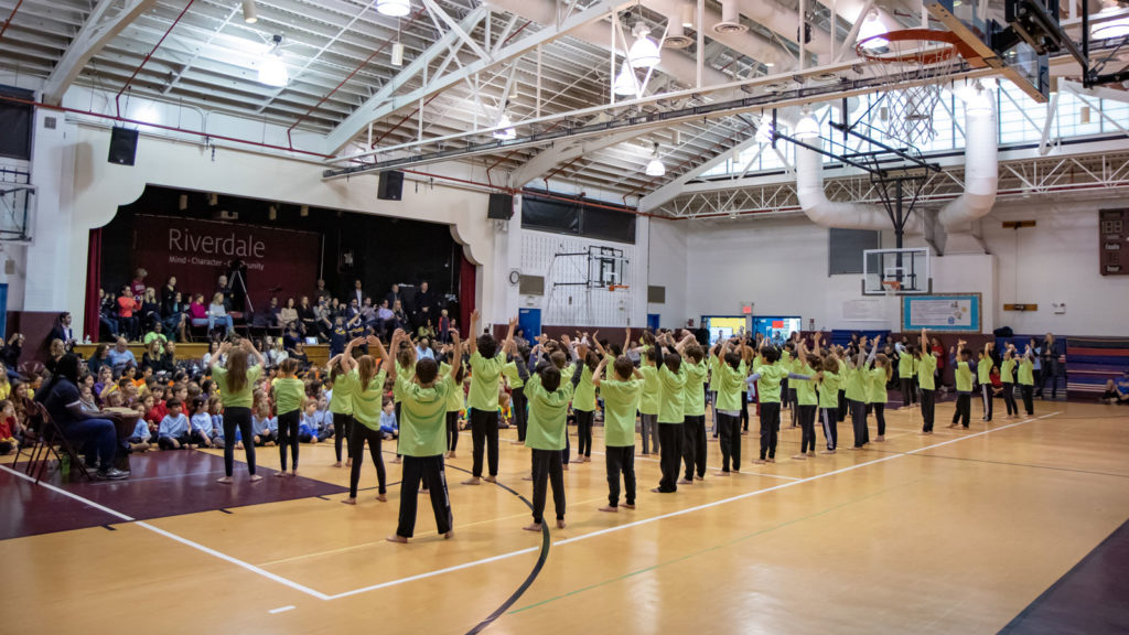 A student performance in the gym/auditorium.