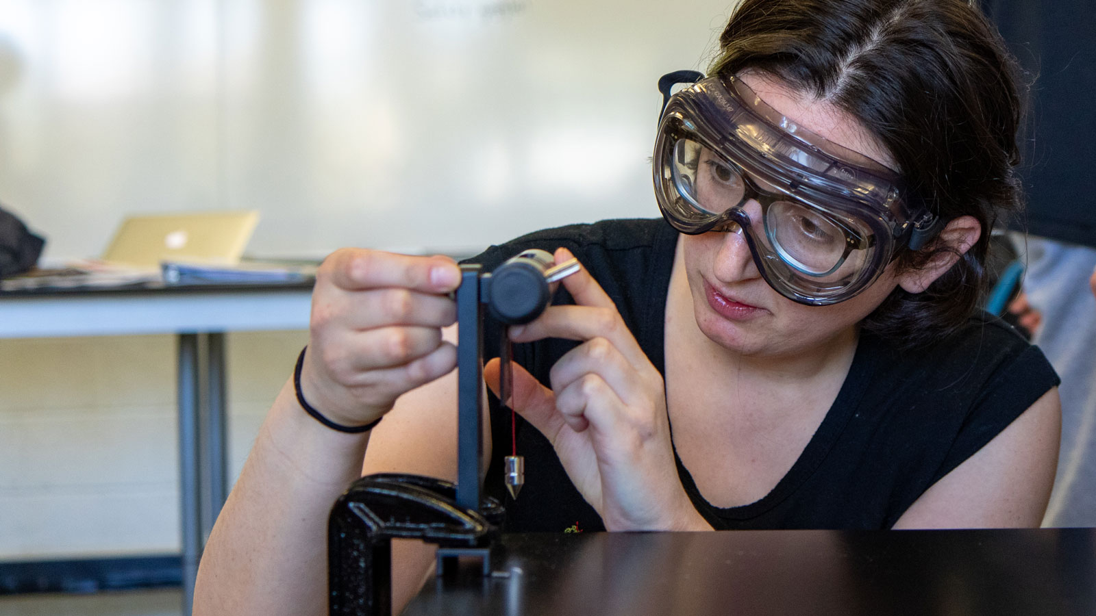 Pesia Soloveichik sets up a lab for her physics class.