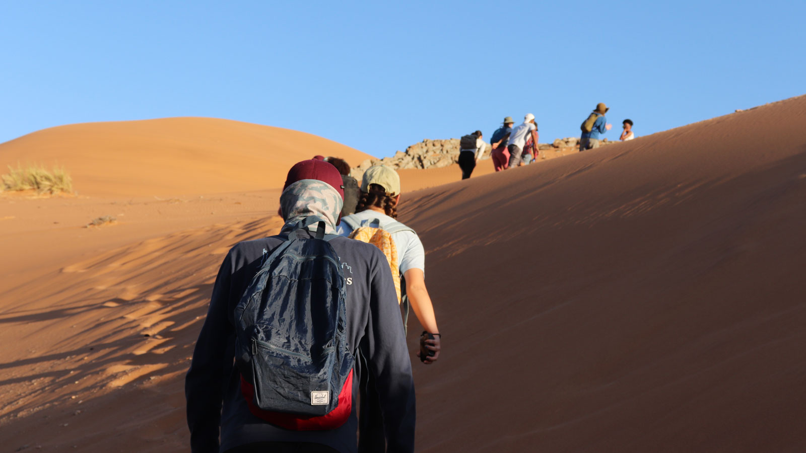 Students trek in the desert in Namibia.