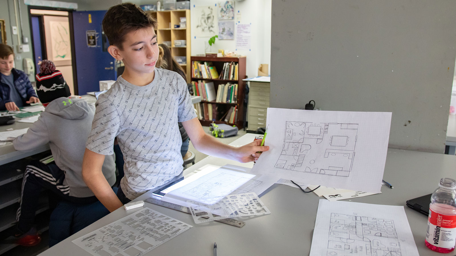 A Middle School student works on an apartment floor plan.