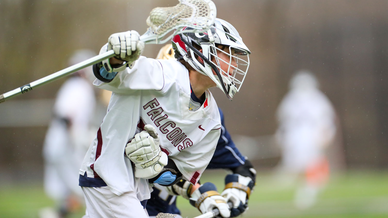 A boy lacrosse player during a game.