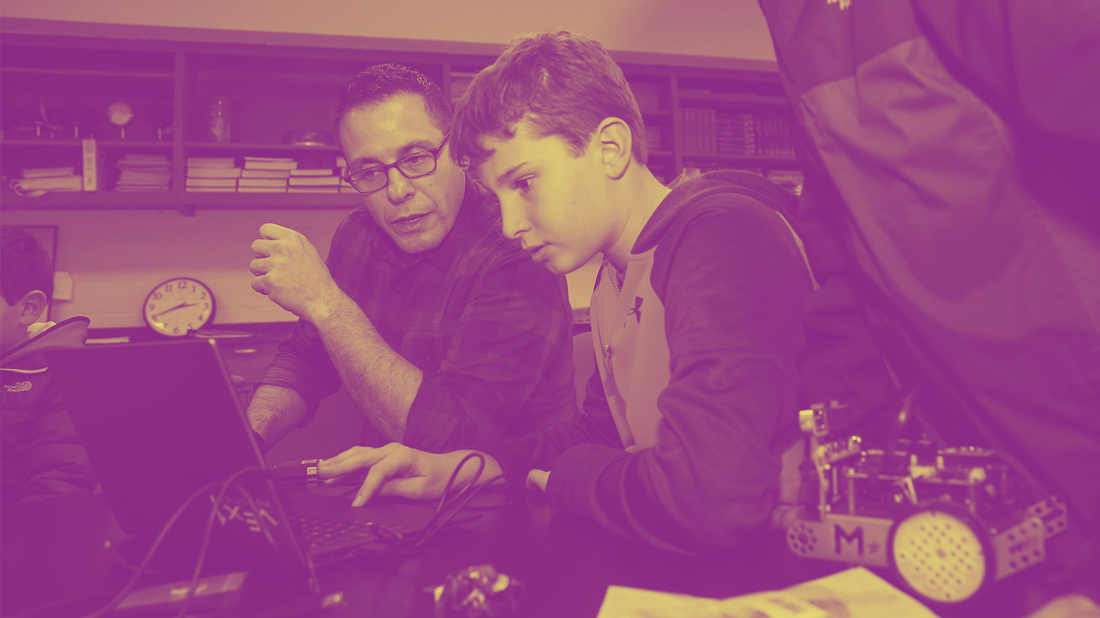 Andrew Abate, head of Computer Science, works with a student on coding.