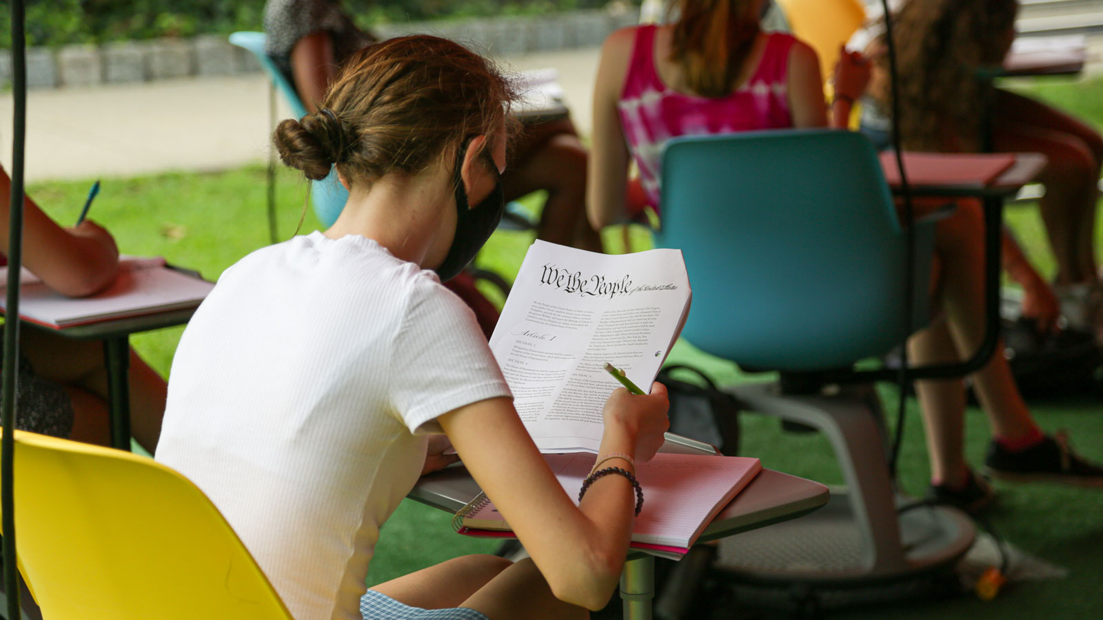 A constitutional law class is taught outside during the COVID-19 pandemic.