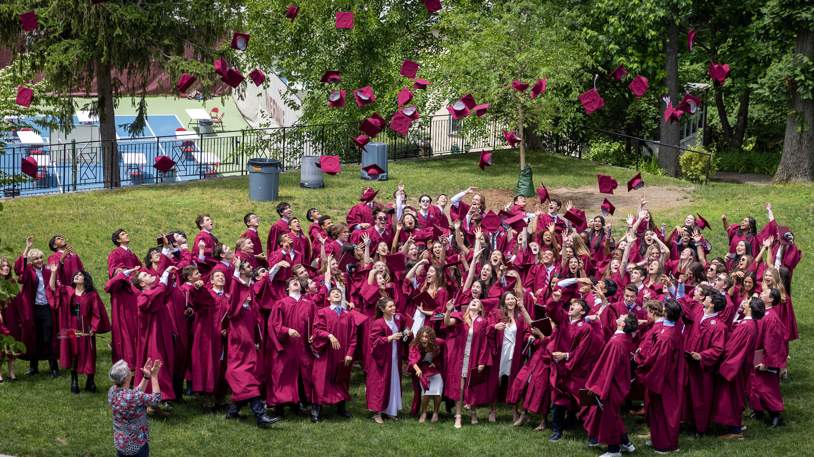 Class of 2021 throws their caps following graduation.