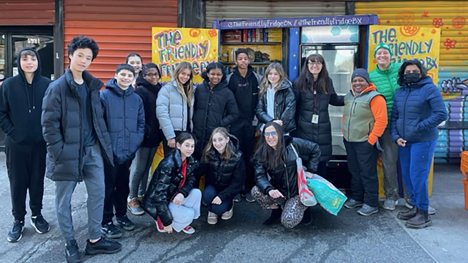 Group photo in front of the Riverdale Friendly Fridge.