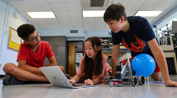 Kids working on a laptop.