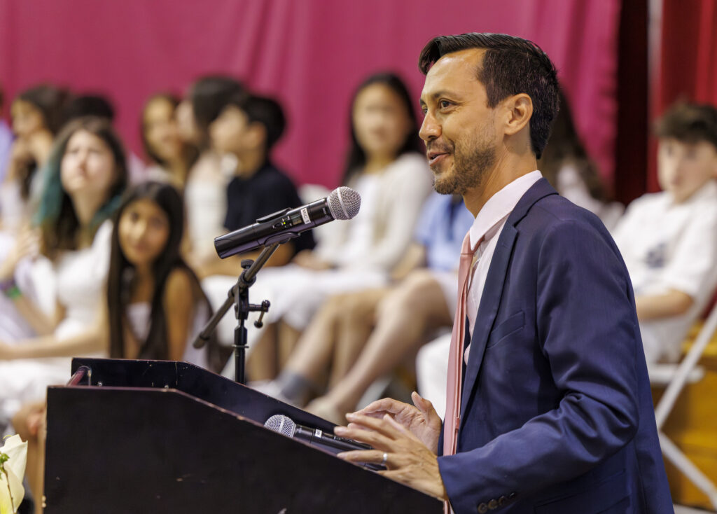A faculty member speaks at a podium