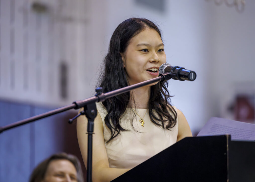 A student speaks at a microphone