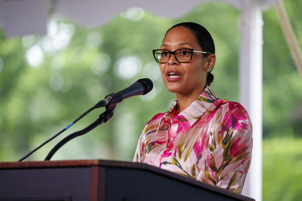 A woman speaks at a podium.